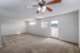 Located at 1210 Calle Jules in Vista, CA, this one-bedroom, one-bathroom residence offers a thoughtfully laid-out single-floor plan with a bright, neutral palette throughout. The combined living and dining area is generously sized, featuring soft carpeting, a textured ceiling, and a ceiling fan. Natural light filters in through multiple windows with vertical blinds, and a sliding door provides direct access to one of two balconies, extending the living space outdoors.

The kitchen is efficiently designed with warm oak cabinetry extending to the ceiling for ample storage, white countertops, light wood-look flooring, and stainless steel appliances including a range and refrigerator. A pass-through peninsula connects the kitchen to the living and dining area, making it functional for both cooking and entertaining.

The bedroom is carpeted and well-lit by a large window with outdoor views, and features a full-wall sliding closet with clean white panel doors. Additional storage is provided by two more closets throughout the unit, with a total of three closets available.

The bathroom includes a wood-vanity with a wide mirror and medicine cabinet. Connecting hallways provide smooth flow between rooms. The overall ambiance is clean, bright, and move-in ready.