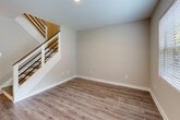 Located at 2788 Defoors Ferry Rd NW in Atlanta, GA, this two-story, 2-bedroom, 1-bathroom home is thoughtfully laid out across two well-proportioned floors. The main level opens into a welcoming living room finished with hardwood-style flooring, neutral walls, and natural light streaming through multiple windows. The space flows into a combined dining area and kitchen, where a large sliding glass door provides direct outdoor access and fills the room with abundant natural light and greenery views. The kitchen features white shaker cabinetry, dark stone countertops, a subway tile backsplash, and stainless steel appliances, including a bottom-freezer refrigerator. A dedicated laundry area with a top-load washer and tankless water heater adds everyday convenience. Upstairs, the generously sized primary bedroom is distinguished by a warm terracotta accent wall, a ceiling fan, and a natural window view. The second bedroom offers plush carpeting, a ceiling fan, and a sliding-door closet. The full bathroom includes a tiled tub/shower combo with a window for natural ventilation. With four closets throughout, this home offers ample storage to complement its practical and comfortable layout.