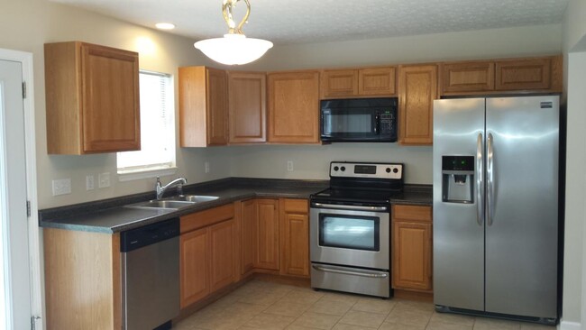 Kitchen with stainless appliances - 1613 Cedar Tree Ln