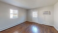 Located at 134 Ridgewood Ave in Pleasantville, NJ, this two-story home offers a well-organized layout with warm, classic character throughout. Rich hardwood flooring runs continuously across both levels, adding warmth and cohesion to every room.

The main floor welcomes you with a central hallway that connects the living spaces and leads toward a bright entry door at the rear. A generously sized living area provides an open, versatile space bathed in natural light from multiple windows fitted with blinds. Adjacent to the living area, the kitchen features white cabinetry, dark hardware, and a sink with ample counter space, offering a clean and functional workspace.

The staircase, with its classic wood treads and white risers, leads to the upper level where the bedrooms are situated. Each bedroom is well-proportioned with hardwood floors, natural light from windows, baseboard heating, and wall-unit air conditioning for year-round comfort. Closets with built-in rods provide practical storage solutions in multiple rooms.

The bathroom is finished with light tile flooring, a white vanity, and a full tub and shower combination with tiled surround, presenting a clean and straightforward design.

Throughout the home, neutral wall tones and white trim create a bright, airy ambiance that complements the natural warmth of the hardwood floors.