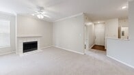 Located at 800 Lakeside Cir in Lewisville, TX, this single-floor, 3-bedroom, 2-bathroom residence offers a well-organized layout designed for comfortable everyday living. The living room serves as the central gathering space, featuring neutral-toned carpet, crown molding, a ceiling fan with light fixture, and a classic tile-surround fireplace that adds warmth and character to the room. An entryway with hardwood-style flooring provides a welcoming transition into the home.

The spacious primary bedroom is a standout feature, outfitted with plush carpet, a ceiling fan, and direct access to a private balcony through sliding glass doors, offering pleasant outdoor views. It also connects to a dedicated en-suite bathroom and a generous walk-in closet equipped with built-in wire shelving for ample storage. The en-suite bathroom features a glass-enclosed walk-in shower with marble-style tile surround, gray cabinetry, and rich hardwood-style flooring. The second bathroom mirrors the refined finishes, offering a tub-shower combination, matching gray cabinetry, and the same warm hardwood-style flooring. The secondary bedrooms feature soft carpet, ceiling fans, and windows that invite natural light. A utility room and additional closet complete this thoughtfully arranged home.