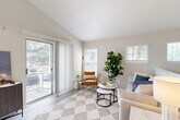 Located at 300 Cityline Ave NE in Atlanta's vibrant Old Fourth Ward neighborhood, this one-bedroom, one-bathroom residence offers a well-designed open-concept layout filled with natural light. The living room serves as the heart of the home, featuring light wood-style flooring, vaulted ceilings, and multiple windows with plantation shutters. A sliding glass door opens directly to a private balcony, extending the living space outdoors with views of the surrounding greenery.

The kitchen is thoughtfully appointed with white shaker cabinetry, granite countertops, a double stainless steel sink, and a full suite of stainless steel appliances including a gas range and refrigerator. A peninsula counter connects the kitchen to the living area, enhancing the open flow of the space.

The carpeted bedroom is generously proportioned, featuring a bay-style window arrangement that floods the room with natural light and provides pleasant outdoor views. A dedicated closet and direct access to the bathroom add functional convenience.

The bathroom is clean and classic, offering a granite vanity, tub-shower combination with tiled surround, and wood-look flooring that ties the space together. Throughout the residence, a neutral color palette and consistent finishes create a cohesive, modern aesthetic.