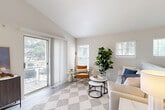 Located at 300 Cityline Ave NE in Atlanta's vibrant Old Fourth Ward neighborhood, this one-bedroom, one-bathroom residence offers a well-designed open-concept layout filled with natural light. The living room serves as the heart of the home, featuring light wood-style flooring, vaulted ceilings, and multiple windows with plantation shutters. A sliding glass door opens directly to a private balcony, extending the living space outdoors with views of the surrounding greenery.

The kitchen is thoughtfully appointed with white shaker cabinetry, granite countertops, a double stainless steel sink, and a full suite of stainless steel appliances including a gas range and refrigerator. A peninsula counter connects the kitchen to the living area, enhancing the open flow of the space.

The carpeted bedroom is generously proportioned, featuring a bay-style window arrangement that floods the room with natural light and provides pleasant outdoor views. A dedicated closet and direct access to the bathroom add functional convenience.

The bathroom is clean and classic, offering a granite vanity, tub-shower combination with tiled surround, and wood-look flooring that ties the space together. Throughout the residence, a neutral color palette and consistent finishes create a cohesive, modern aesthetic.
