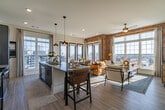 Located in the heart of Memphis, this 2-bedroom, 3-bathroom residence at 7 Vance Avenue blends industrial character with contemporary design. Exposed red brick walls are a defining architectural feature throughout, adding warmth and texture to the living spaces alongside light hardwood flooring.

The living room is a bright, inviting retreat anchored by expansive grid-pane windows that frame sweeping city views and flood the space with natural light. A ceiling fan and ceiling-height brick walls amplify the lofty, open feel.

The kitchen is well-appointed with two-tone cabinetry, stainless steel appliances, a large granite-topped island with bar seating, and stylish pendant lighting. It flows seamlessly into the dining area, which features floor-to-ceiling glass doors opening to a balcony with panoramic downtown views.

The primary bedroom is a generously sized sanctuary with an exposed brick accent wall and direct access to an en-suite bathroom featuring dual sinks, granite countertops, and bold blue cabinetry. The second bedroom is bright and airy, with large windows offering additional city views. Two closets and three full bathrooms round out a thoughtfully designed floor plan suited for comfortable urban living.