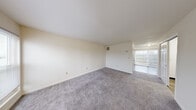 Located at 530 Forest Park Ct in Dayton, Ohio, this two-story unit offers four bedrooms, one bathroom, and a practical layout evenly divided between both floors. The main level features a carpeted living area with neutral cream-toned walls, a sliding door that brings in natural light and outdoor views, and a kitchen positioned behind a half-wall peninsula. The kitchen is equipped with warm wood cabinetry, granite-style countertops, a coil-top range, dishwasher, and refrigerator, with wood-look tile flooring and a window that provides additional natural light. A carpeted staircase with a wood handrail connects the two floors via hallways on each level. The upper floor houses the bedrooms, including a generously sized primary bedroom with a walk-in closet featuring built-in shelving. Additional bedrooms are carpeted with neutral walls and ample outlets. The full bathroom includes a tub-shower combination, a vanity with a white countertop, wood-style tile flooring, and clean white finishes throughout. The overall aesthetic is clean, neutral, and move-in ready.