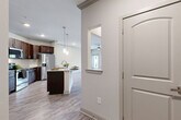 Located at 5403 W 96th Ave in Westminster, CO, this single-floor, 2-bedroom, 2-bathroom home offers a thoughtfully designed layout with quality finishes throughout. The open-concept living, dining, and kitchen area serves as the heart of the home, featuring light wood-look flooring, crown molding, and a ceiling fan. Large windows and a glass door flood the living space with natural light and provide outdoor access. The kitchen is a standout, showcasing rich dark cabinetry with brushed nickel hardware, granite countertops, a subway tile backsplash, stainless steel appliances, and a central island with pendant lighting. A pantry adds convenient storage. Both bedrooms are carpeted and include ceiling fans and windows with outdoor views, creating bright, comfortable retreats. The primary bathroom is well-appointed with a dual-sink vanity featuring granite countertops, dark wood cabinetry, wood-look flooring, and a full tub-shower combination. Three closets provide ample storage throughout. A dedicated laundry room includes a full-size washer and dryer. A utility room and hallway complete the functional floor plan, making this a well-rounded and move-in-ready home.