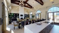 This elegant single-floor gathering space showcases an impressive open-concept layout designed for both socializing and entertaining. The defining architectural feature is the soaring vaulted ceiling adorned with rich, dark-stained exposed wood beams, complemented by a series of wrought-iron chandelier fixtures that cast warm, inviting light throughout the room. Large arched windows and sets of French doors line the walls, flooding the interior with generous natural light and offering views to the outdoors. The floors are finished in large-format neutral ceramic tile, lending a clean and cohesive feel across the entire space. A spacious lounge area anchors one side of the room, furnished with comfortable sofas and accent chairs arranged around a central coffee table, alongside built-in dark wood bookshelves and a fireplace with a mounted television. A dining area with a substantial dark wood table and upholstered chairs provides ample seating for gatherings. The fully equipped kitchen is outfitted with dark espresso cabinetry, stainless steel appliances including double wall ovens and a dishwasher, a green glass tile backsplash, crisp white quartz countertops, and a generous central island. The overall ambiance is refined yet welcoming, blending Mediterranean-inspired architectural details with contemporary furnishings.
