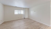 Located at 441–449 Graham Rd in Cuyahoga Falls, Ohio, this two-bedroom, one-bathroom unit offers a clean and functional single-floor layout. The living room welcomes you with light wood-style flooring, neutral white walls, a textured ceiling, and a wide window that invites natural light into the space. The kitchen is finished with large-format tile flooring, white cabinetry, a gas range, refrigerator, and an overhead exhaust hood, complemented by a ceiling fan and a window overlooking greenery outside. Both bedrooms continue the light wood-style flooring and are brightened by natural light from windows with outdoor views. The primary bedroom features a ceiling fan with light fixture, while the secondary bedroom includes a built-in closet with sliding doors, providing practical storage. The bathroom offers tile flooring, a white vanity with drawers, and ample cabinetry. Throughout the unit, the bright white palette and consistent flooring create a cohesive and airy atmosphere. The efficient layout makes thoughtful use of every area, providing comfortable living across the home's well-organized rooms.