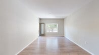 Located at 3055 Floyd Ave in Modesto, California, this single-story 2-bedroom, 2-bathroom residence offers a clean, modern design with a thoughtfully organized layout. The living room serves as the heart of the home, featuring light wood-style flooring, neutral gray walls, and a ceiling fan with lighting. A large window allows natural light to pour in while offering views of mature trees outside, creating a bright and airy atmosphere. A glass-panel door provides additional access to the outdoors.

The kitchen is outfitted with light maple cabinetry, dark granite-style countertops, and wood-look flooring that flows seamlessly into the hallways, connecting the main living areas with ease.

The spacious primary bedroom includes plush carpeting, a ceiling fan, and direct access to its own private bathroom and closet, offering a practical en-suite arrangement. The second bedroom also features carpeting and a built-in desk area with upper cabinetry and dark countertop — ideal as a workspace or study nook — along with its own closet and nearby bathroom access.

Both bathrooms are finished with wood-look flooring, light maple vanities, and dark countertops. Two hallways guide circulation throughout the home, keeping the floor plan intuitive and efficient. The overall aesthetic is clean, contemporary, and move-in ready.