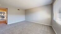 Located at 2461 Damascus Road in Augusta, Georgia, this two-story residence offers a functional and well-organized layout across two floors. The main level features a kitchen equipped with warm-toned wood cabinetry, white appliances including a refrigerator, dishwasher, and range, complemented by a double sink and durable hardwood-style flooring. A hallway connects the kitchen to the rest of the lower level, which also includes a full bathroom with a tiled tub-and-shower combination and chrome fixtures.

Carpeted bedrooms are found on both floors, each finished in neutral tones with white trim and multiple doors providing access to closets or adjoining spaces. The primary bedroom benefits from a ceiling fan, a sliding glass door that opens to a private balcony with outdoor views, and an abundance of natural light. The second bedroom features two doors and plush carpeting, offering a similarly comfortable and versatile space.

Both floors are accessible via staircases, and each level includes its own bathroom, adding convenience and privacy. Throughout the residence, a consistent neutral color palette, clean white baseboards, and practical flooring choices create a cohesive and move-in-ready atmosphere suited for everyday living.