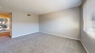 Located at 2461 Damascus Road in Augusta, Georgia, this two-story residence offers a functional and well-organized layout across two floors. The main level features a kitchen equipped with warm-toned wood cabinetry, white appliances including a refrigerator, dishwasher, and range, complemented by a double sink and durable hardwood-style flooring. A hallway connects the kitchen to the rest of the lower level, which also includes a full bathroom with a tiled tub-and-shower combination and chrome fixtures.

Carpeted bedrooms are found on both floors, each finished in neutral tones with white trim and multiple doors providing access to closets or adjoining spaces. The primary bedroom benefits from a ceiling fan, a sliding glass door that opens to a private balcony with outdoor views, and an abundance of natural light. The second bedroom features two doors and plush carpeting, offering a similarly comfortable and versatile space.

Both floors are accessible via staircases, and each level includes its own bathroom, adding convenience and privacy. Throughout the residence, a consistent neutral color palette, clean white baseboards, and practical flooring choices create a cohesive and move-in-ready atmosphere suited for everyday living.