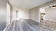Located on Avocado Street in Costa Mesa, California, this single-story, one-bedroom, one-bathroom residence offers a thoughtfully designed layout that maximizes every square foot. Light-toned, wood-style flooring runs consistently throughout the space, lending a cohesive and contemporary feel to each room.

The living room is generously proportioned, with large windows that invite abundant natural light and provide views of the surrounding neighborhood. Neutral wall tones complement the bright, airy atmosphere, while a dedicated hallway connects the main living areas with ease.

The kitchen is smartly laid out, featuring crisp white cabinetry, a stylish mosaic tile backsplash, recessed lighting, and stainless steel appliances including a full-size refrigerator and dishwasher. Light countertops complete the clean, modern aesthetic.

The bedroom offers a comfortable footprint with a natural light source from a window with blinds, and benefits from a full mirrored sliding-door closet that enhances the sense of space. The bathroom is well-finished with a white vanity, framed mirror, brushed nickel hardware, and a shower-tub combination. Clean lines and neutral tones carry throughout, creating a consistent and polished ambiance across the entire residence.