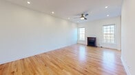 Located at 1100 Meagan Ct in Elgin, Illinois, this three-floor home offers a thoughtfully designed layout with consistent finishes throughout. The main living area features light hardwood flooring and a fireplace framed by two large windows that invite natural light and outdoor views, creating a warm, open atmosphere. The kitchen is well-equipped with warm-toned wood cabinetry, granite countertops, stainless steel appliances including a gas range and dishwasher, and a sliding glass door that opens to an outdoor view, further enhancing the bright character of the space. A staircase with a classic wood baluster connects the floors with visual continuity. Upper-level rooms continue the hardwood flooring theme, with one room featuring a ceiling fan and a window overlooking neighboring rooftops. A well-organized walk-in closet includes built-in shelving and drawers for ample storage. Bathrooms are finished with marble-style tile flooring and wall surrounds, white cabinetry, and clean fixtures. A dedicated laundry area with a full-size washer and dryer adds everyday convenience. The lower level offers a versatile open room with recessed lighting and tile flooring, suitable for a variety of uses.