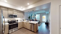 Located at 6825 Alabama Ave in the Canoga Park neighborhood of Los Angeles, this single-story residence showcases a thoughtfully designed open-concept layout with modern finishes throughout. The kitchen is a standout feature, equipped with stainless steel appliances including a French door refrigerator, electric range, built-in microwave, and dishwasher. Light wood-tone cabinetry extends to the ceiling, complemented by crisp white quartz countertops and a peninsula with pendant lighting that serves as both a workspace and casual dining area. Wood-style flooring runs through the kitchen and living areas, creating a seamless flow. The living room receives generous natural light through large windows with plantation shutters and offers direct access to an outdoor balcony. The bedroom is carpeted for comfort, featuring windows with blinds for natural light and ample wall space. A bathroom with clean, neutral finishes completes the layout. Recessed lighting throughout the unit, tray ceiling details in the kitchen, and a neutral color palette contribute to the space's bright, contemporary ambiance, making it a well-appointed residence in the heart of Los Angeles.