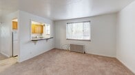 Located at 450 Jefferson Avenue in Pittsburgh, PA, this one-bedroom, one-bathroom unit offers a compact and efficiently arranged single-floor layout. Soft wall-to-wall carpeting runs throughout the living and sleeping areas, lending a warm and comfortable feel to the space.

The living room is bright and welcoming, featuring a large window with blinds that invites natural light and garden views. A classic cast-iron radiator provides reliable warmth, and a pass-through window connects the living area to the kitchen, creating an open and communicative flow between the two spaces. The kitchen features warm-toned wood cabinetry, a gas range, and a refrigerator, with its own window allowing for additional natural light.

The generously sized bedroom accommodates a ceiling fan with a light fixture and benefits from dual windows that frame leafy outdoor views, creating a bright and airy retreat. A classic radiator in the bedroom further ensures year-round comfort.

The bathroom is clean and functional, finished with white tile flooring, a full bathtub with shower, a toilet, and a wood-toned vanity with storage. A frosted window provides natural light while maintaining privacy.

Overall, this unit presents a straightforward, well-lit living space with traditional architectural details and practical amenities, well-suited for comfortable everyday living in the Pittsburgh area.