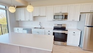 This contemporary 1040 square foot apartment in Victoria, MN offers a thoughtfully designed living space with two bedrooms and two bathrooms. The open-concept layout seamlessly integrates the kitchen, living, and dining areas, creating a spacious and airy atmosphere. Large windows throughout the apartment flood the rooms with natural light and provide picturesque views of the surrounding area.

The kitchen boasts sleek white cabinetry, stainless steel appliances, and ample counter space, perfect for culinary enthusiasts. The primary bedroom, measuring 170 square feet, offers a generous retreat with plush carpeting and a sizeable closet. The bathrooms feature modern fixtures, including a double vanity in one, and light-toned wood flooring that complements the overall design aesthetic.

Throughout the apartment, you'll find a harmonious blend of materials, including wood-look flooring in the main living areas and soft carpeting in the bedrooms. The neutral color palette creates a calming ambiance and allows for personalization. Additional features include recessed lighting, a dedicated closet space, and a private balcony accessible from the living area, offering an extension of the living space for outdoor enjoyment.