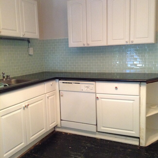 Kitchen black granite countertop and blue glass - 535 Belle Ave