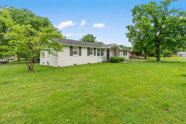 Front view of large yard (landscaping included in rent :) - 701 Revels Dr