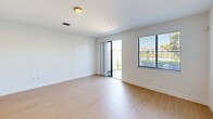 This contemporary townhouse in Miramar, Florida offers a well-designed living space across two floors, totaling 1270 square feet. The ground floor spans 580 square feet, while the upper level provides 690 square feet of living area. The home features three bedrooms, including a spacious 170-square-foot primary bedroom, and three full bathrooms.

The heart of the home is an open-concept living area that seamlessly integrates the kitchen and living room. The kitchen boasts modern amenities, including stainless steel appliances, granite countertops, and ample cabinet space. Pendant lighting and track lighting add a stylish touch to the space.

Throughout the home, light-colored walls and light wood-look flooring create a bright, airy atmosphere. Large windows in the bedrooms and living areas allow natural light to flood the space, while offering views of the surrounding area. The bathrooms feature clean, white fixtures and neutral tones for a fresh, modern look.

Additional amenities include a single-car garage, central air conditioning with ceiling fans for comfort, and a staircase connecting the two levels. The property's location at CAT 12-126 in Miramar (ZIP code 33025) provides convenient access to local amenities and transportation routes.