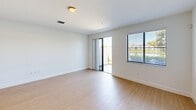 This contemporary townhouse in Miramar, Florida offers a well-designed living space across two floors, totaling 1270 square feet. The ground floor spans 580 square feet, while the upper level provides 690 square feet of living area. The home features three bedrooms, including a spacious 170-square-foot primary bedroom, and three full bathrooms.

The heart of the home is an open-concept living area that seamlessly integrates the kitchen and living room. The kitchen boasts modern amenities, including stainless steel appliances, granite countertops, and ample cabinet space. Pendant lighting and track lighting add a stylish touch to the space.

Throughout the home, light-colored walls and light wood-look flooring create a bright, airy atmosphere. Large windows in the bedrooms and living areas allow natural light to flood the space, while offering views of the surrounding area. The bathrooms feature clean, white fixtures and neutral tones for a fresh, modern look.

Additional amenities include a single-car garage, central air conditioning with ceiling fans for comfort, and a staircase connecting the two levels. The property's location at CAT 12-126 in Miramar (ZIP code 33025) provides convenient access to local amenities and transportation routes.