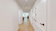 Located in the heart of Beverly Hills, this thoughtfully designed 3-bedroom, 4-bathroom residence offers a refined living experience across a well-appointed single floor. Light oak hardwood flooring flows throughout, anchoring a clean, modern aesthetic defined by white walls and recessed lighting.

The open-concept kitchen is a standout, featuring light wood cabinetry, dramatic marble slab backsplash and countertops, a waterfall-edge island with bar seating, and stainless steel appliances including a built-in double oven. Pendant lighting and open shelving add warmth and function to the space, which connects seamlessly to the dining area.

The living room offers a calm, neutral palette with ample natural light and direct access to a private balcony. The covered outdoor space features polished concrete finishes and overlooks lush, mature trees — an ideal retreat in an urban setting.

The generously sized primary bedroom includes large sliding glass doors to the balcony and a custom walk-in closet with built-in shelving, drawers, and hanging space in light wood finishes. The bathrooms are spa-like, featuring large-format stone tile, floating vanities, glass-enclosed showers, and matte black hardware accents. A dedicated water closet adds further privacy and convenience to the primary suite.