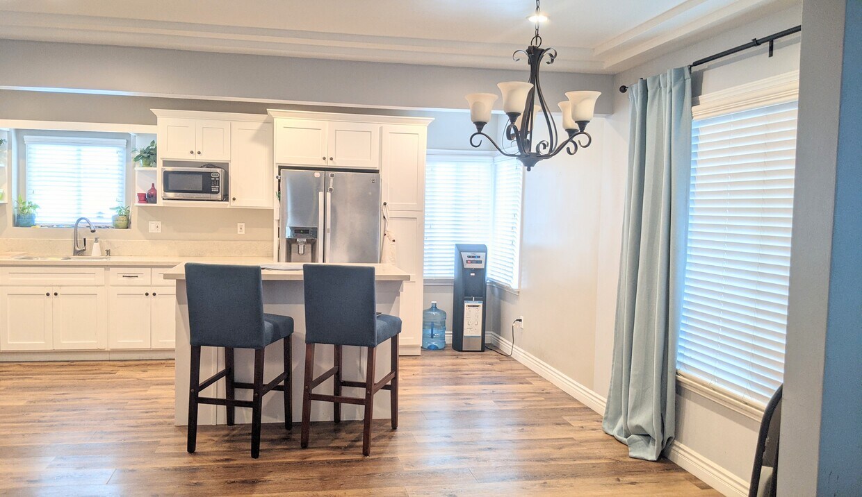 Recently renovated kitchen with White shaker cabinets, open layout to dining area. Appliances not in - 8184 Madison Ave