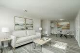Located at 512 Swadley Rd in Johnson City, TN, this single-floor apartment offers 820 square feet of functional living space across 2 bedrooms and 2 bathrooms. The unit features consistent luxury vinyl plank flooring throughout, neutral gray walls, and clean white trim, creating a cohesive and modern aesthetic.

The kitchen is well-appointed with white shaker-style cabinetry, gray countertops, a classic white subway tile backsplash, a stainless steel sink, and black appliances including a refrigerator and electric range, plus an over-the-range microwave. The galley-style layout maximizes efficiency.

The primary bedroom measures 200 square feet and includes a closet with built-in shelving. The second bedroom features a window with blinds, allowing for natural light and outdoor views. Both bedrooms carry the same warm, neutral tones found throughout the unit.

Each bathroom is finished with white vanities, modern brushed nickel fixtures, large mirrors with overhead lighting, and vinyl plank flooring. One bathroom features a walk-in shower area and a dedicated closet for added storage. Two hallways connect the spaces, contributing to a practical and navigable floor plan throughout the home.