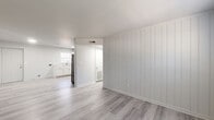 Located at 2531 Ladeara Crest Ln in Winston-Salem, NC, this single-story, 3-bedroom, 2-bathroom home offers a clean and modern aesthetic throughout. Light gray vinyl plank flooring runs consistently across all rooms, creating a cohesive and low-maintenance foundation. A standout design detail is the vertical shiplap accent wall featured in the living area and select bedrooms, lending a contemporary farmhouse character to the interior.

The living room is bright and open, with natural light filtering through windows and a clear sightline into the kitchen. The kitchen is well-appointed with white shaker-style cabinetry, light countertops, an under-cabinet range hood, and black appliances including an electric range and refrigerator, complemented by a window above the sink.

The three bedrooms are finished in a neutral palette with clean white walls. The primary bedroom offers a comfortable footprint, while the additional bedrooms each include closets and accent wall detailing. A hallway connects the private areas of the home efficiently.

Both bathrooms are bright and functional. One features a white vanity with a framed mirror and multi-bulb lighting fixture, while the other includes a full tub-shower combination with white subway tile surround and brushed nickel fixtures. The overall design is fresh, minimal, and move-in ready.