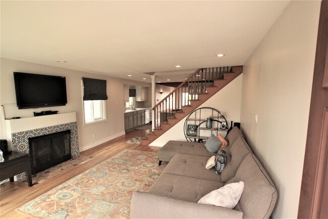 Living room and decorative fireplace gets lots of natural light. - 765 Avenue A
