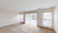 Located at 4339 Riverside Dr in Dayton, OH, this single-floor unit offers five bedrooms, two bathrooms, a living room, and a central hallway connecting all spaces. The living room is generously sized, featuring plush carpeting, large sliding glass doors with vertical blinds, and multiple windows that flood the space with natural light and provide outdoor views. Adjacent to the living room, the kitchen is equipped with warm-toned wood cabinetry, a black appliance, and a pass-through counter that connects to the main corridor. The hallway, finished with hardwood-style flooring, serves as the spine of the layout, providing efficient access to all rooms. The bedrooms are carpeted and well-lit, with several featuring windows overlooking the exterior. One bedroom showcases a standout exposed brick wall, adding a distinctive architectural character. Another bedroom includes a sliding double-door closet for added storage. The two bathrooms are cleanly finished with wood-toned vanities, mirror lighting, and tile-style flooring; one features a pedestal sink for a streamlined look. Throughout, the neutral color palette and consistent finishes create a cohesive, functional living environment.