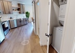 This 450 square foot apartment in Fargo, North Dakota, offers a thoughtfully designed living space that maximizes functionality and style. The single-floor layout comprises three distinct areas, each tailored for comfort and efficiency.

The kitchen is a standout feature, boasting sleek, light-colored cabinetry with ample storage. Stainless steel appliances, including a side-by-side refrigerator, built-in microwave, and electric range, complement the modern aesthetic. A striking hexagonal tile backsplash adds visual interest, while quartz countertops provide a durable work surface.

The bedroom, though compact, exudes comfort with a plush, upholstered headboard and neutral bedding. A contemporary art piece adorns the wall, adding a touch of sophistication. Thoughtful lighting, including a floor lamp, creates a warm ambiance.

The living area features mid-century inspired furniture, including leather armchairs and a wooden coffee table. A large window floods the space with natural light and offers views of the surroundings. The room is accented by modern artwork and a cozy area rug.

Throughout the apartment, light wood flooring unifies the space, while recessed lighting and strategically placed lamps ensure ample illumination. The bathroom, while not pictured in detail, appears to maintain the same modern, clean aesthetic evident throughout the home.

This apartment demonstrates that small-space living can be both stylish and functional, offering a perfect blend of comfort and contemporary design in the heart of Fargo.