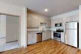 Located at 1905 Riverside Pkwy in Douglasville, GA, this single-floor 2-bedroom, 2-bathroom residence offers a well-designed, functional layout. The open-concept living and kitchen area creates a seamless flow, anchored by warm hardwood-style flooring that runs throughout the main living spaces. The kitchen is outfitted with light wood cabinetry, granite-look countertops, and a full suite of stainless steel appliances including a refrigerator, range, microwave, and dishwasher — providing both style and practicality. The living room benefits from natural light and includes a ceiling fan for added comfort. Both bedrooms are carpeted and generously sized, each featuring ceiling fans, windows with blinds that invite natural light, and access to dedicated closets equipped with wire shelving systems for organized storage. The spacious primary bedroom offers ample room for furnishings. The two bathrooms each feature hardwood-style flooring, vanities with updated cabinetry, and practical fixtures; one includes a shower-tub combination. A neutral color palette throughout the home creates a clean, move-in-ready ambiance suitable for a variety of décor styles.