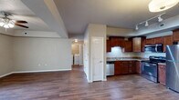 This well-appointed 2-bedroom, 2-bathroom residence in Waterloo, Iowa offers a thoughtfully designed single-floor layout that maximizes both comfort and functionality. The open-concept living, dining, and kitchen area serves as the heart of the home, featuring rich hardwood-style flooring and a tray ceiling with a ceiling fan in the living room that adds architectural character. A sliding glass door connects the living area to a covered wooden deck, ideal for outdoor relaxation.

The kitchen is well-equipped with rich cherry-toned cabinetry, granite-style countertops, and a full suite of stainless steel appliances, including a range, microwave, dishwasher, and refrigerator. A pantry provides additional storage convenience.

The spacious primary bedroom features a tray ceiling, ceiling fan, and hardwood-style flooring. The second bedroom offers plush carpet, a natural window view, and a double-door closet. Both bathrooms are clean and functional, with one featuring a full soaking tub and shower combo.

Additional highlights include an in-unit laundry area, a utility room, multiple closets throughout, and a connecting hallway that ties the layout together efficiently. The neutral color palette and practical finishes throughout create a move-in-ready environment.