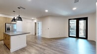 Located at 1300 40th St in Denver's Cole neighborhood, this thoughtfully designed one-bedroom, one-bathroom residence offers a modern aesthetic throughout its well-appointed single-floor layout. The open-concept living and kitchen area is anchored by wide-plank wood-look flooring, recessed lighting, and clean white walls that create a bright, airy atmosphere. A large black-framed sliding door leads to a private balcony, allowing natural light to flow generously into the living space.

The kitchen is a standout feature, showcasing light wood cabinetry with matte black hardware, dark slate-toned countertops, a bold dark tile backsplash, and stainless steel appliances including a gas range, built-in microwave, and French door refrigerator. A central island with pendant lighting provides additional prep space and casual seating.

The bedroom is carpeted for comfort, features a ceiling fan, and includes a large black-framed window with city views. Two closets offer ample storage throughout the unit. The bathroom continues the modern design language with a wood-toned vanity, dark countertop, a large mirror, gold-accented fixtures, and a tiled walk-in shower. This residence delivers a cohesive, contemporary living experience in a vibrant Denver location.
