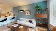 Located at 427 S Hill St in Downtown Los Angeles, this one-bedroom unit offers a thoughtfully designed single-floor layout with modern finishes and a cohesive color palette. Light wood-tone flooring flows throughout the space, complementing crisp white walls and signature teal accent walls that add depth and character to multiple rooms.

The open-concept kitchen seamlessly connects to the living area, featuring white shaker cabinetry, a gray subway tile backsplash, white quartz countertops, and a full suite of stainless steel appliances, including a refrigerator, electric range, microwave, and dishwasher. Pendant lighting over the peninsula enhances both function and style.

The living area benefits from large windows that invite natural light and offer views of the surrounding urban environment. The space is well-proportioned, providing comfortable room for lounge seating and a workspace area.

The bedroom features a bold dark teal accent wall, a large window with exterior views, light wood flooring, and ample space for a full bedroom suite. The bathroom is finished with neutral large-format tile, a white vanity, and a tub-shower combination. A dedicated entryway corridor with recessed lighting completes the layout.