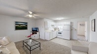 Located at 114 Brownlea Dr in Greenville, NC, this single-story, one-bedroom, one-bathroom home offers a practical and well-organized floor plan. The open-concept living area flows directly into the kitchen, making efficient use of the available space. The living room features soft carpeting, a ceiling fan with light fixture, and windows that allow natural light to fill the room, creating a bright and welcoming atmosphere.

The kitchen is outfitted with white cabinetry, a double-basin sink, white appliances including a range and refrigerator, and light-toned countertops. Tile flooring in the kitchen provides a clean, easy-to-maintain surface.

The spacious primary bedroom is generously sized, accommodating a full bedroom suite with room to spare. It features carpet flooring, a closet, a window for natural light, and a wall-mounted HVAC unit. The full bathroom includes a tub/shower combination and a vanity with storage.

The exterior of the home features a brick facade, and the property includes a private patio area enclosed by a wooden fence — ideal for outdoor relaxation. The textured ceilings throughout give the home a classic residential feel. Overall, this home offers a functional, comfortable layout well-suited for individuals or couples in Greenville, NC.