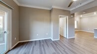 Located at 10270 E Taron Dr in Elk Grove, CA, this single-story 2-bedroom, 3-bathroom home offers a thoughtfully designed layout with modern finishes throughout. The open-concept kitchen and living area serves as the heart of the home, featuring white shaker cabinetry, a white quartz peninsula with breakfast bar seating, stainless steel appliances including a refrigerator with ice maker, range, and microwave, plus recessed lighting and crown molding that add a polished touch. Light wood-look flooring flows throughout the main living areas, complementing the neutral warm-gray wall tones. The spacious primary bedroom includes direct outdoor access through a windowed door, plush carpet flooring, and a generously sized walk-in closet with wire shelving. The second bedroom is equally well-proportioned with soft carpet and ample natural light. The bathrooms are clean and contemporary, featuring white vanity cabinetry with quartz countertops and soaking tub/shower combinations with white tile surrounds. A dedicated laundry room provides added convenience with overhead cabinetry for storage and space for a full-size washer and dryer. Two closets offer practical storage solutions throughout the home, completing this well-appointed residence.