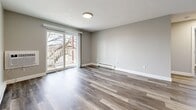 Located at 141 Sea St in Quincy, MA, this thoughtfully updated 2-bedroom, 1-bathroom unit offers a clean, modern aesthetic across a single floor of living space. Durable wood-style plank flooring flows seamlessly throughout every room, complemented by soft neutral gray walls and crisp white trim that create a bright, cohesive atmosphere.

The open living room is generously proportioned, featuring large windows and a sliding glass door that opens to a private balcony, filling the space with natural light and providing outdoor access. Baseboard heating runs along the walls, ensuring efficient warmth throughout the colder months.

The kitchen is well-equipped with white cabinetry, marble-style countertops, a stainless steel range, a dishwasher, and a stainless sink — offering a clean, functional layout ideal for everyday cooking.

The spacious primary bedroom features dual windows overlooking the surrounding neighborhood, a built-in closet with bifold doors, and baseboard heating. The second bedroom is equally bright, with natural light from a large window. Both rooms carry the same consistent wood-style flooring and neutral palette found throughout the unit.

The bathroom is finished in all-white with a full tub-shower surround, a white vanity, and chrome fixtures, delivering a clean and functional design. Overall, the unit presents a move-in ready space with modern updates throughout.