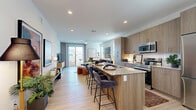 Located at 6250 S 40th St in Phoenix, AZ, this well-appointed 2-bedroom, 2-bathroom single-story home offers a thoughtfully designed open-concept layout. The combined kitchen and living area serves as the heart of the home, anchored by a generous granite-topped island with bar seating — ideal for casual dining or entertaining. The kitchen features warm wood-toned cabinetry extending to the ceiling, a full suite of stainless steel appliances, and light wood-style flooring that runs throughout the home. The living room is bright and inviting, with a sliding glass door opening to a private outdoor patio, allowing natural light to flow through the space. The primary bedroom is a comfortable retreat, complete with a ceiling fan, large windows, and dedicated closet space. The second bedroom offers similar comfort with its own ceiling fan and generous natural light. Both bathrooms are finished with granite-topped vanities and wood-toned cabinetry. The primary bath features a dual-sink vanity and walk-in shower, while the second bathroom includes a shower-tub combination. Two closets provide ample storage throughout. Clean white walls and consistent light flooring tie the entire home together with a modern, cohesive aesthetic.
