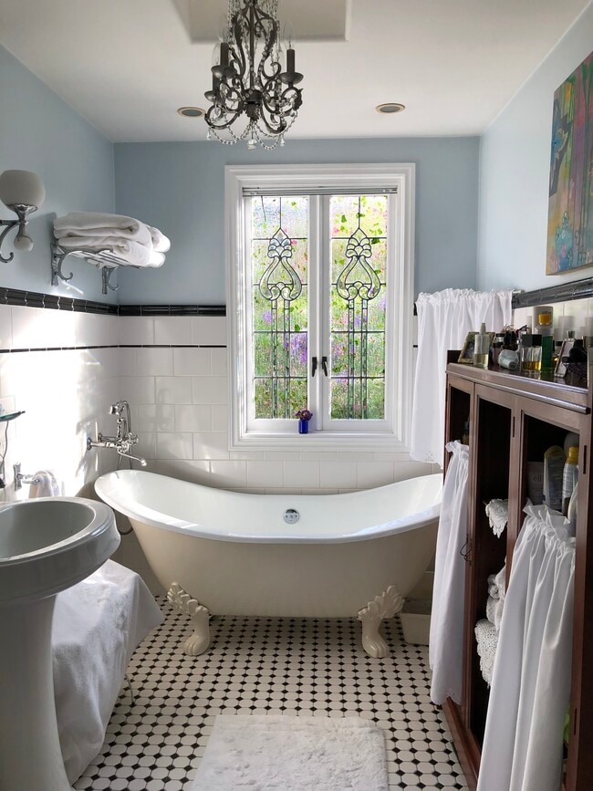 Deep claw foot tub, tile and skylight. - 1034 Amoroso Pl