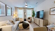 This one-bedroom, one-bathroom residence at 8288 Chicago Avenue in Douglasville, GA offers a thoughtfully designed layout that maximizes every square foot of its single-floor plan. Wood-style flooring flows seamlessly throughout, lending warmth and visual continuity to each space.

The open-concept kitchen and living area serves as the heart of the home. The kitchen is outfitted with crisp white shaker cabinetry extending to the ceiling, granite countertops, a subway tile backsplash, stainless steel appliances including a range, microwave, and refrigerator, and a central island with pendant lighting — ideal for both meal preparation and casual dining. The adjoining living room is bright and inviting, featuring large windows that admit generous natural light.

The spacious primary bedroom comfortably accommodates a full suite of furniture and includes a ceiling fan, large windows with views of the outdoors, and direct access to the bathroom and closet. The bathroom features granite-topped vanity cabinetry and wood-style tile flooring, with a walk-in closet conveniently accessible from within. The overall ambiance of the residence is clean, modern, and move-in ready, with neutral tones that complement a variety of décor styles.