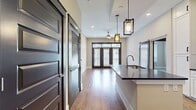 This 830-square-foot apartment offers a well-designed living space with two bedrooms and two bathrooms. The single-floor layout maximizes efficiency, with the primary bedroom boasting a generous 140 square feet. The open-concept design combines the kitchen and living room, creating a spacious feel and facilitating easy entertaining.

The interior showcases a modern aesthetic with neutral tones and clean lines. Hardwood flooring extends throughout, adding warmth and durability. A standout feature is the stylish sliding door with a dark frame, providing a striking contrast against the light walls and offering flexible room division.

Large windows allow abundant natural light to flood the space, enhancing the sense of openness. The apartment includes two closets for storage and a hallway connecting the various rooms. While compact, the thoughtful design ensures each area serves its purpose effectively.

The neutral color palette, featuring off-white walls and trim, creates a blank canvas for personalization. This contemporary apartment combines functionality with aesthetic appeal, making it an ideal space for modern urban living.