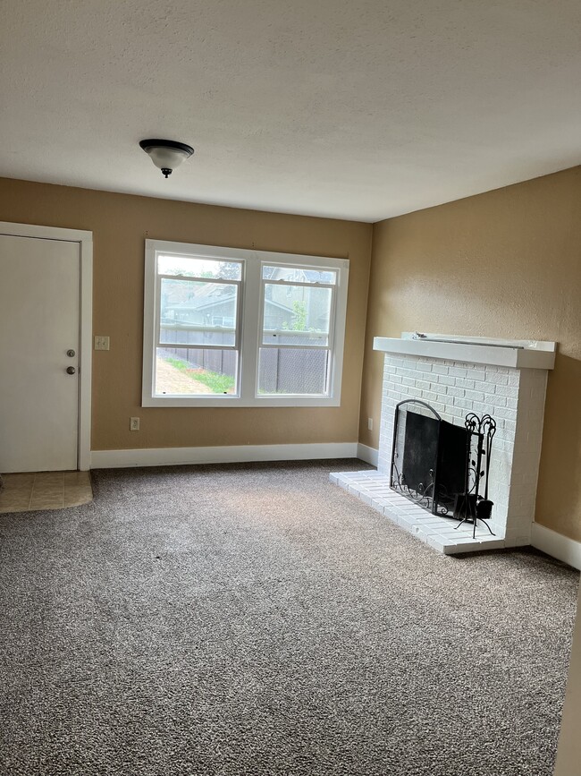 living room with wood burning fireplace - 441 16th St SE
