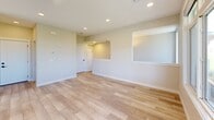 Located in the Sage Hill community of Calgary, this contemporary two-storey home offers 3 bedrooms and 3 bathrooms thoughtfully distributed across two well-proportioned floors. The main level features an open-concept kitchen and living area bathed in natural light from large windows that frame views of the surrounding green landscape. The kitchen is a standout, showcasing a large central island with a undermount sink, crisp white cabinetry, a bold dark tile backsplash, stainless steel appliances including a built-in microwave, and striking black pendant lights overhead. Light wood-look flooring flows seamlessly throughout, adding warmth to the modern aesthetic. A balcony off the main level offers unobstructed views of the rolling green hillside under open Alberta skies, framed by warm wood architectural accents and a sleek glass railing. Upstairs, the three bedrooms provide comfortable retreats, with the primary bedroom offering generous proportions and access to natural light and outdoor views. The bedrooms feature sliding panel closets and light hardwood flooring. The three bathrooms are finished in a clean, contemporary style, with one featuring dual vessel sinks, modern matte black fixtures, and a full tub-shower combination with tile surround.