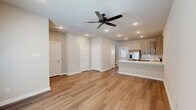 Located at 1340 County Road 1106 in Anna, TX, this two-story home offers a thoughtfully designed layout across two floors. The main level features an open-concept living area with warm wood-look flooring, recessed lighting, and a ceiling fan, creating a bright and welcoming atmosphere. Natural light filters in through windows, enhancing the airy feel of the space.

The kitchen is a standout feature, equipped with stainless steel appliances including a French door refrigerator, electric range, built-in microwave, and dishwasher. Light wood cabinetry, a classic subway tile backsplash, and a crisp white quartz countertop with an integrated sink complete the modern aesthetic. A pantry provides additional storage. The main floor also includes a convenient half bathroom.

Upstairs, two bedrooms offer comfortable retreats, each with wood-look flooring and ceiling fans. The primary bedroom includes an en-suite bathroom and a dedicated closet. The secondary bedroom features its own walk-in closet. Two additional full bathrooms serve the upper level, one featuring a subway-tiled tub-shower combination with wood-toned vanity cabinetry. A laundry area and hallway complete the upper floor, making this home as functional as it is stylish.