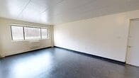 Located at 1610 Edgewood Dr in Danville, Illinois, this single-floor, 3-bedroom, 1-bathroom home offers a straightforward and functional layout. The interior is finished with speckled dark vinyl tile flooring throughout, white walls, and panel ceilings, giving the space a clean and consistent look.

The generously sized primary bedroom is the standout room, offering ample floor space and a large window that brings in natural light with views of the surrounding greenery. The two additional bedrooms are more compact but each features a built-in closet with a hanging rod, providing practical storage. Windows in the secondary bedrooms allow for additional natural light.

The kitchen is equipped with dark wood cabinetry, a coil-burner electric range, a refrigerator, and laminate countertops — offering all the essentials for everyday cooking. Adjacent to the kitchen is a dedicated dining room, creating a defined space for meals. A hallway connects the main living areas to the bedrooms and the full bathroom, which includes a tiled tub-shower combination. A dedicated laundry room adds further convenience to the home's practical layout. Baseboard heating is present throughout, ensuring consistent warmth across the single-floor footprint.