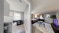 Located at 105 Roney Ln in Syracuse, NY, this single-floor, 3-bedroom, 1-bathroom home offers a thoughtfully arranged layout that maximizes every inch of its compact footprint. The living area welcomes you with light gray walls, smooth light wood-toned flooring, and a window dressed in neutral curtains that invites natural light into the space. Corner shelving adds a touch of character and practicality to the room.

The kitchen is efficiently designed with white cabinetry, white countertops, a gas range, and a full-size refrigerator, all set against the same cohesive gray wall palette and light flooring that runs throughout the home.

The spacious primary bedroom is a standout, featuring a radiator beneath a bright window, gray curtains, and ample room for a full furniture arrangement. A second bedroom offers a cheerful, light-filled environment with bold teal curtains, a classic white radiator, and natural light streaming through window blinds.

The bathroom is clean and well-appointed, featuring a white vanity with a built-in sink, a framed mirror, and open shelving for storage. A connecting hallway links all rooms cohesively. The consistent gray tone throughout the home creates a calm, unified ambiance well-suited for everyday living.
