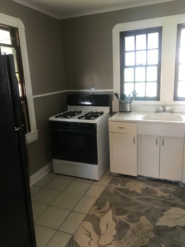 Kitchen pictured from living room - 704 Avenue G Apartments