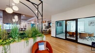 Located at 601 Flaugherty Run Rd in Coraopolis, PA, this thoughtfully designed amenity center spans a single, generously proportioned floor and offers a diverse range of spaces to accommodate work, wellness, and recreation. The welcoming entry area features warm hardwood flooring, stylish seating, lush indoor planters, and striking black-framed architectural details that set a modern, sophisticated tone throughout.

The open lounge and recreation area serves as the social hub of the space, complete with a pool table, comfortable seating arrangements, a chandelier overhead, and direct sightlines into the adjacent fitness center. The fitness center is well-appointed with cardio equipment including treadmills, stationary bikes, and a rowing machine, complemented by free weights, resistance bands, ceiling fans, wall-mounted TVs, and large mirrors that enhance the sense of space and light.

The kitchen and dining area features a large white quartz island with bar seating, warm wood cabinetry, subway tile backsplash, pendant lighting in copper tones, built-in shelving with a mounted TV, and stainless steel appliances — ideal for gatherings and community events.

The media room offers a large-format projection screen, plush seating, and carpeted flooring for an immersive viewing experience. Two private offices are available for focused work, each equipped with built-in desks and curated artwork. Two bathrooms round out the functional offerings of this versatile, well-appointed facility.