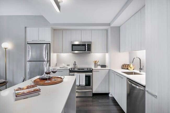 European-style cabinetry with a choice of white wood grain or dark walnut finishes and white lacquer finishes - Signature Reston Town Center Apartments